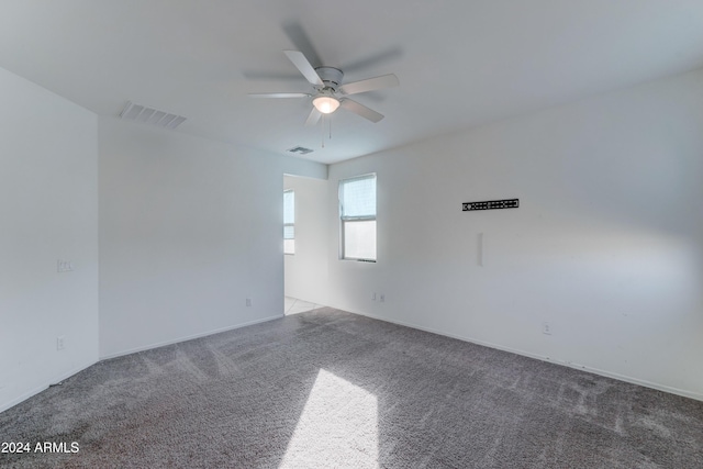 unfurnished room with ceiling fan and carpet