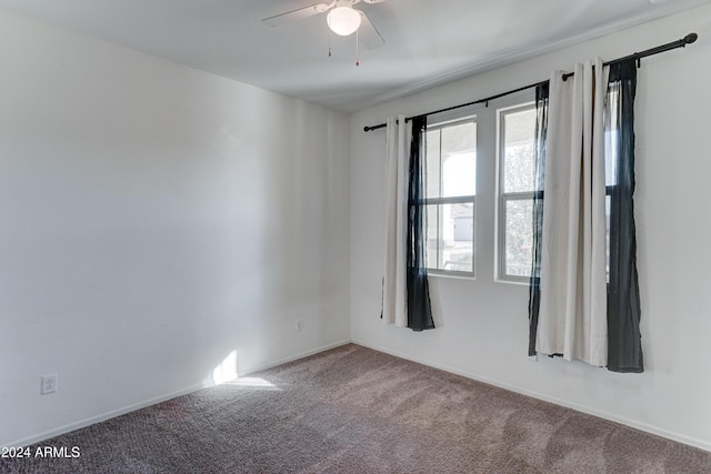 spare room with carpet and ceiling fan