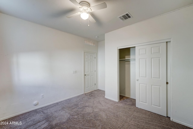 unfurnished bedroom featuring ceiling fan, a closet, and carpet