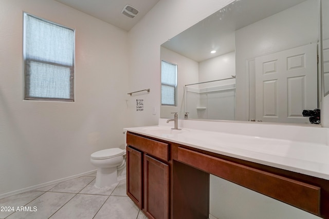 bathroom with tile patterned floors, vanity, toilet, and a shower