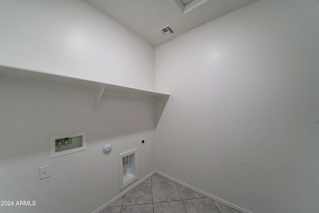 washroom with washer hookup, electric dryer hookup, light tile patterned flooring, and hookup for a gas dryer