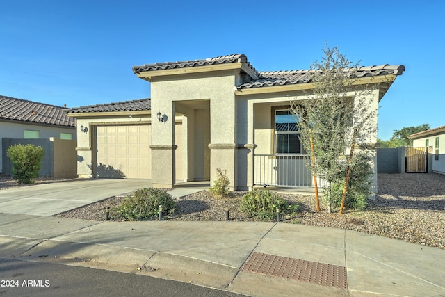 mediterranean / spanish-style home with a garage