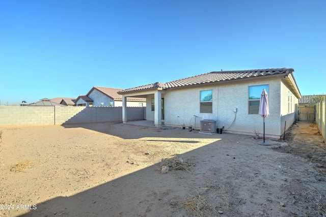 back of house featuring central AC unit