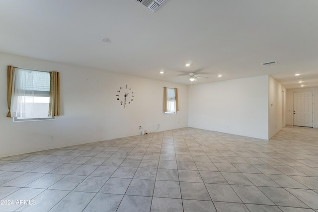 tiled empty room with ceiling fan