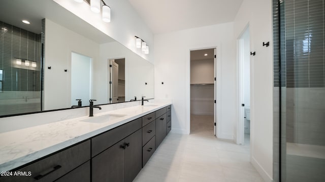 bathroom with walk in shower and vanity