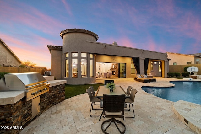 pool at dusk featuring a fenced in pool, a patio, area for grilling, and a fenced backyard