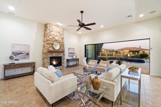 living room featuring visible vents, recessed lighting, a fireplace, and a ceiling fan