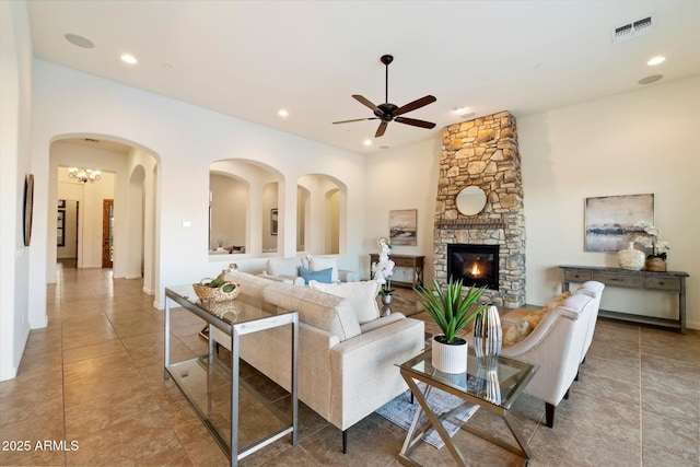 living area featuring visible vents, recessed lighting, a fireplace, and a ceiling fan