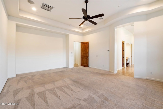 spare room featuring visible vents, recessed lighting, ceiling fan, a raised ceiling, and carpet flooring