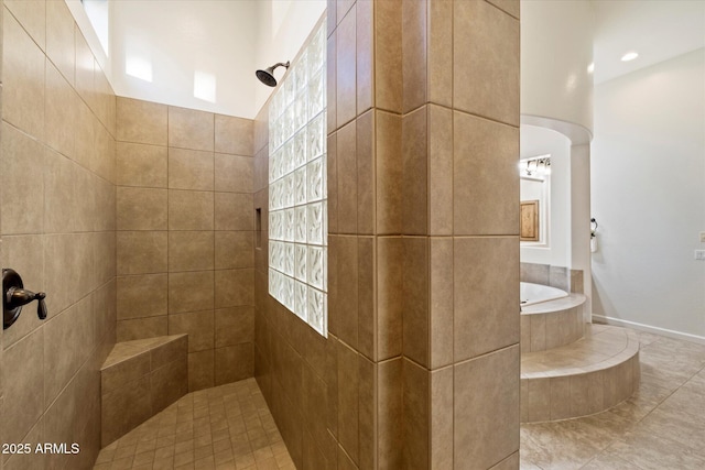 bathroom with a bath and tiled shower