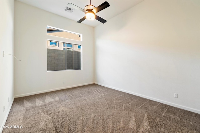 empty room with baseboards, carpet, visible vents, and ceiling fan