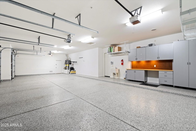 garage featuring a sink and a garage door opener