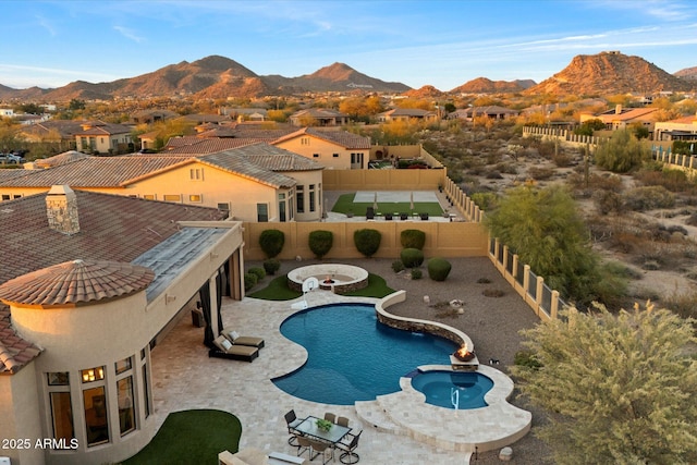 view of pool with a mountain view and a fenced backyard
