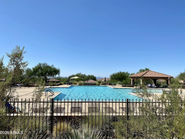 pool with a gazebo and fence