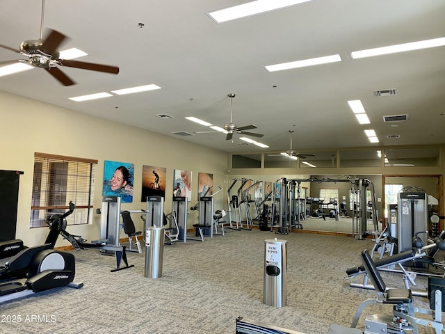 gym featuring carpet, visible vents, and ceiling fan