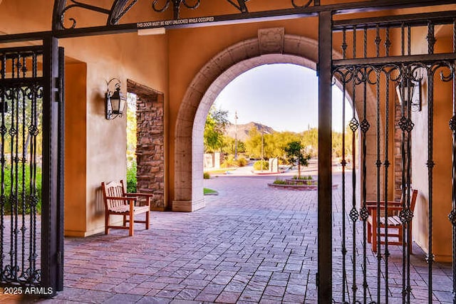 view of patio / terrace with a gate and a mountain view