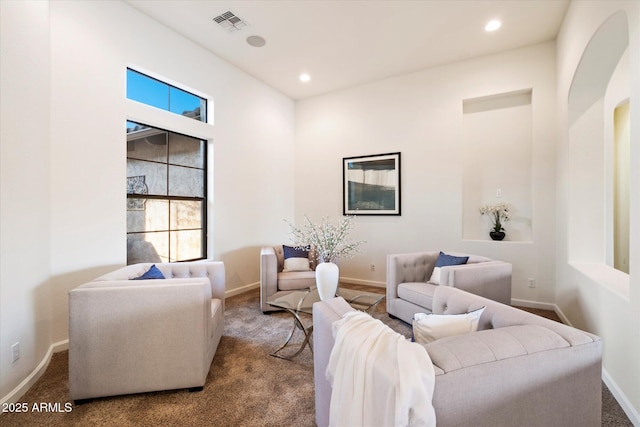 living area featuring recessed lighting, baseboards, visible vents, and carpet floors