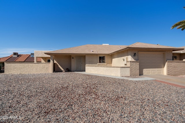 view of front of property with a garage, driveway, and stucco siding