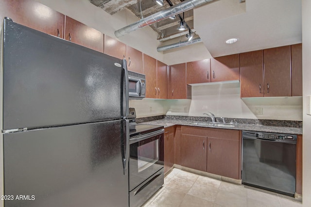 kitchen featuring black appliances, light tile patterned floors, and sink