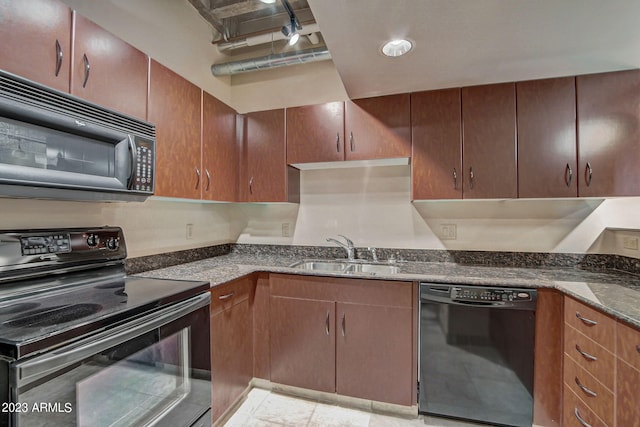 kitchen featuring sink, dark stone countertops, and black appliances