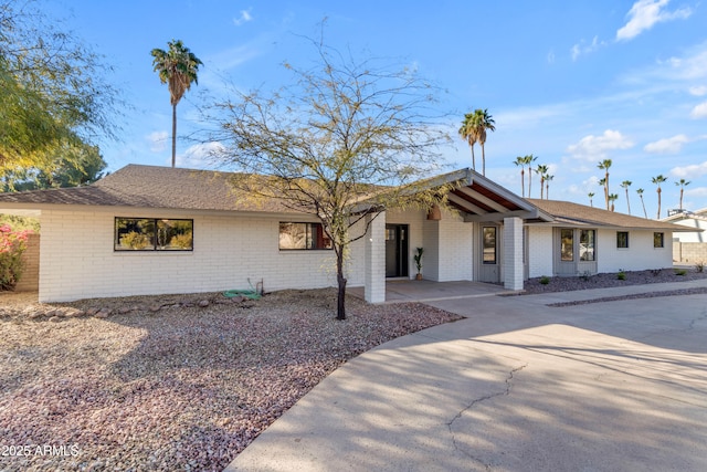 ranch-style house featuring a carport