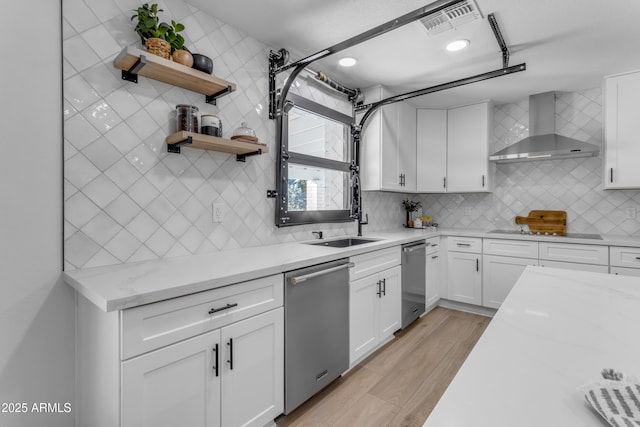 kitchen featuring white cabinets, dishwasher, black electric cooktop, light stone countertops, and wall chimney range hood