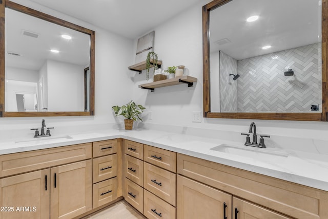 bathroom with vanity and tiled shower