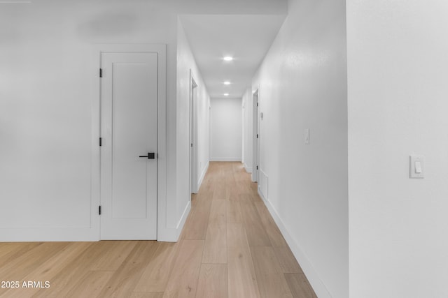 hallway with light hardwood / wood-style flooring