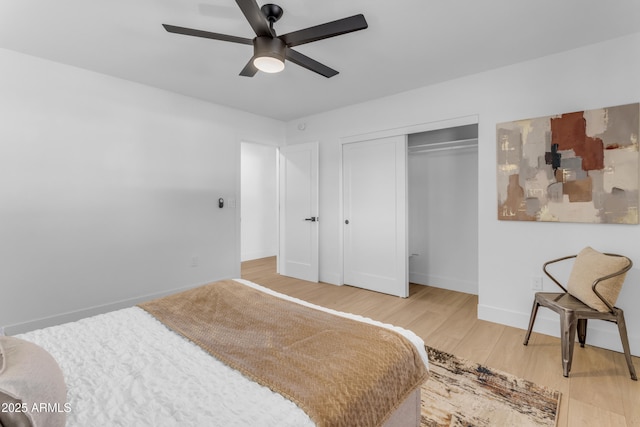 bedroom featuring ceiling fan, hardwood / wood-style floors, and a closet