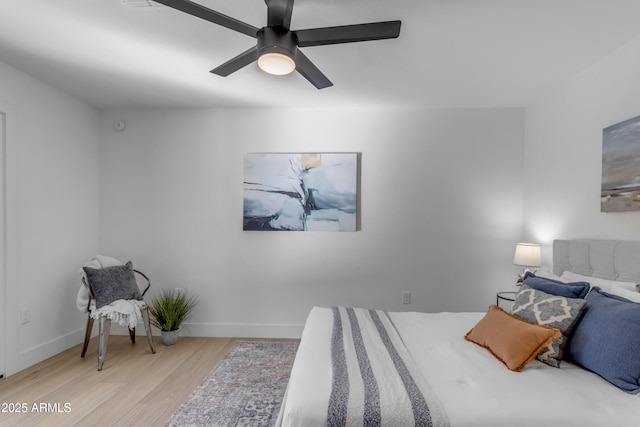 bedroom with ceiling fan and light hardwood / wood-style floors