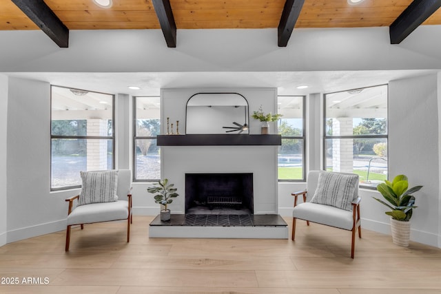 living area with wood ceiling, light wood-type flooring, and vaulted ceiling with beams