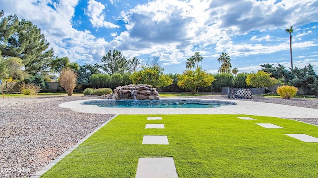 view of pool featuring pool water feature and a lawn