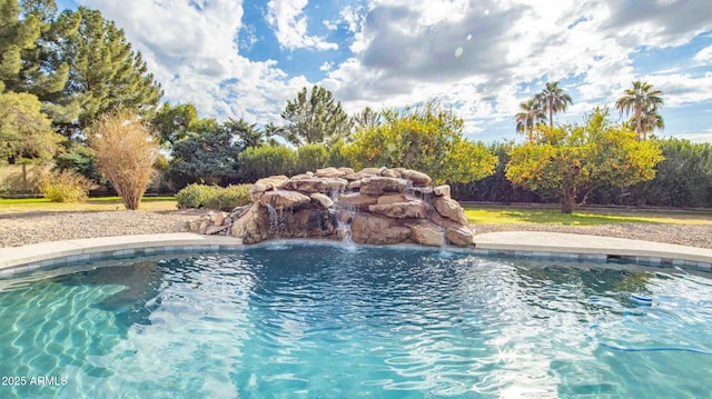 view of swimming pool with pool water feature