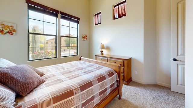 carpeted bedroom featuring baseboards