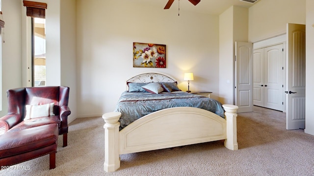 carpeted bedroom featuring visible vents, multiple windows, baseboards, and ceiling fan