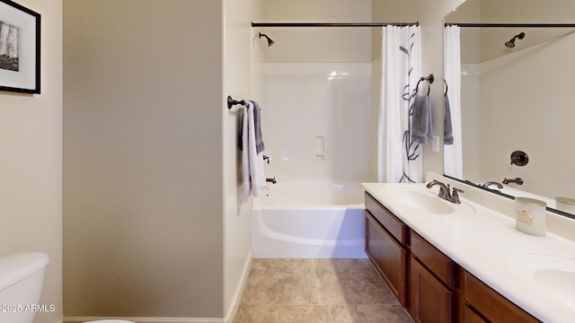 bathroom with baseboards, toilet, double vanity, shower / tub combo, and a sink