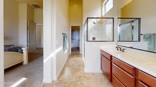 bathroom with visible vents, a shower stall, baseboards, a high ceiling, and a sink