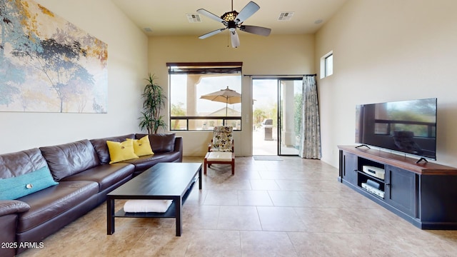 living room featuring light tile patterned floors, visible vents, and ceiling fan