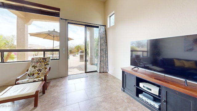 doorway to outside with light tile patterned floors and baseboards