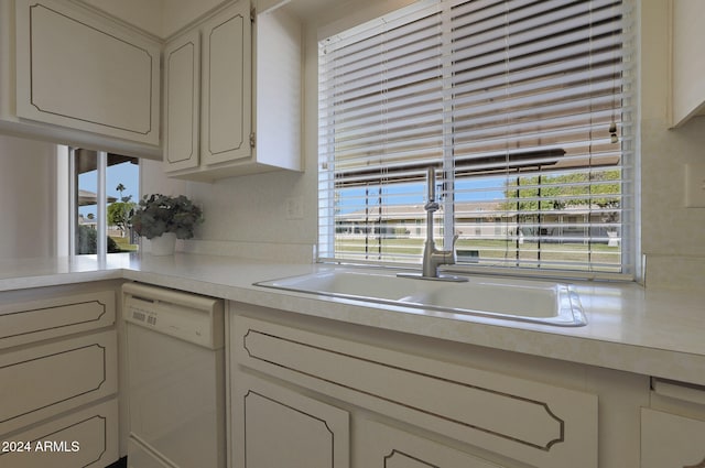 kitchen featuring dishwasher, white cabinetry, and sink