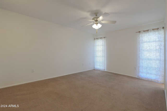 empty room featuring light carpet and ceiling fan