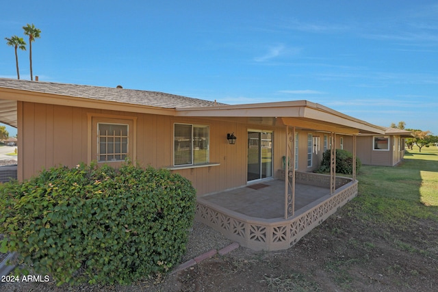 back of property featuring a yard