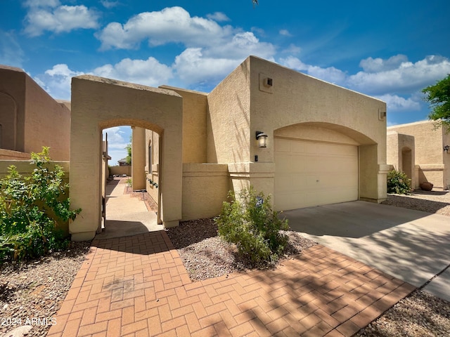 pueblo-style home with a garage