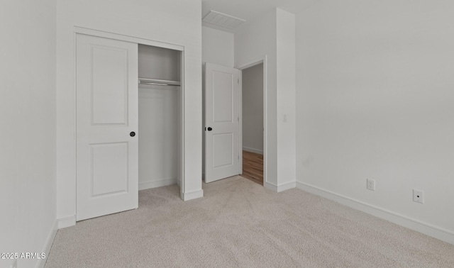 42405 W Peters Dr, Maricopa, AZ 85138 - unfurnished bedroom featuring light carpet, a closet, and baseboards