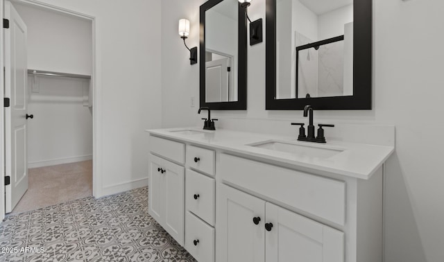 42405 W Peters Dr, Maricopa, AZ 85138 - bathroom with a shower stall, a spacious closet, double vanity, and baseboards