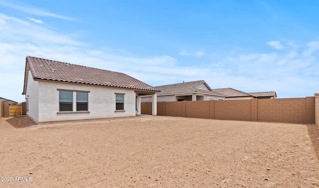 42405 W Peters Dr, Maricopa, AZ 85138 - back of property featuring stucco siding, a tiled roof, and a fenced backyard
