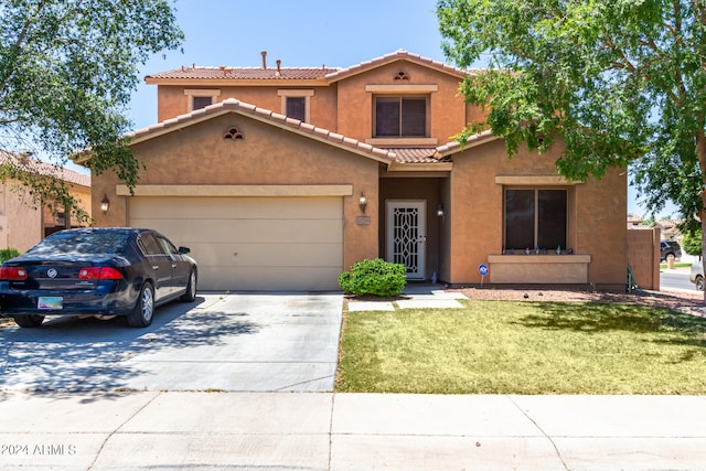 view of front of house featuring a garage and a front lawn