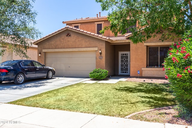 view of front of home featuring a front yard and a garage