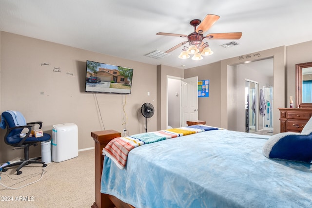 carpeted bedroom featuring ceiling fan and ensuite bath