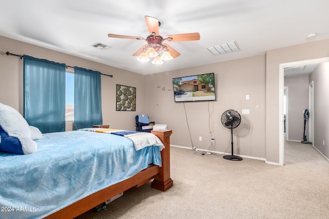 bedroom with ceiling fan and light carpet